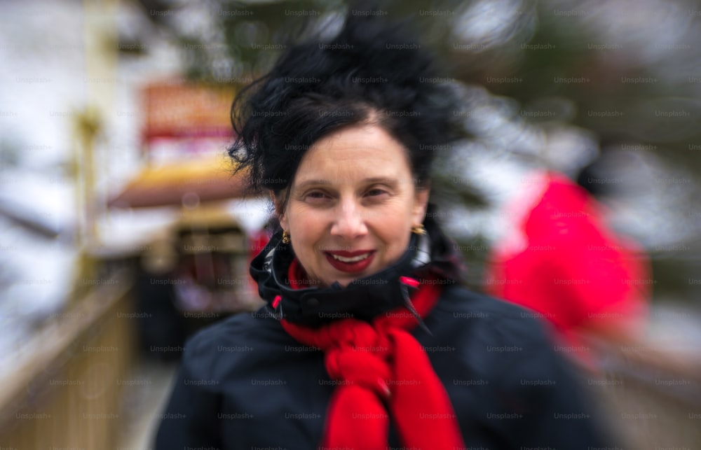 Smiling middle-aged woman in winter clothes on the street
