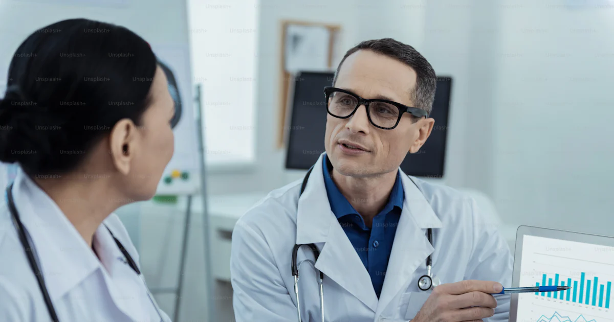 Data analysis. Professiaonl pleasant doctors discussing the statistics ...
