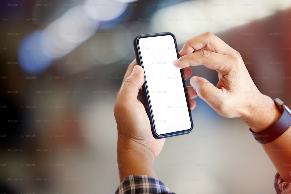 Man using smartphone over blurred background.