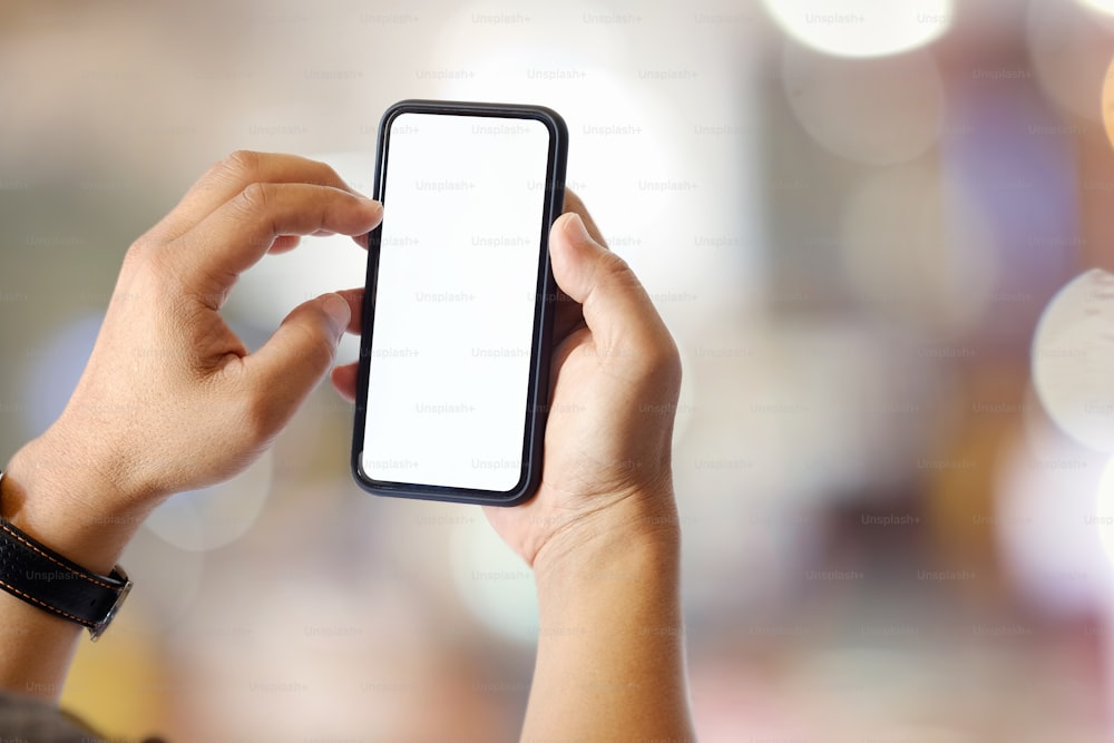 Man using mobile phone over abstract blurred background.