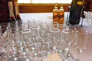 stylish glasses at alcohol bar table at luxury wedding reception, catering in restaurant