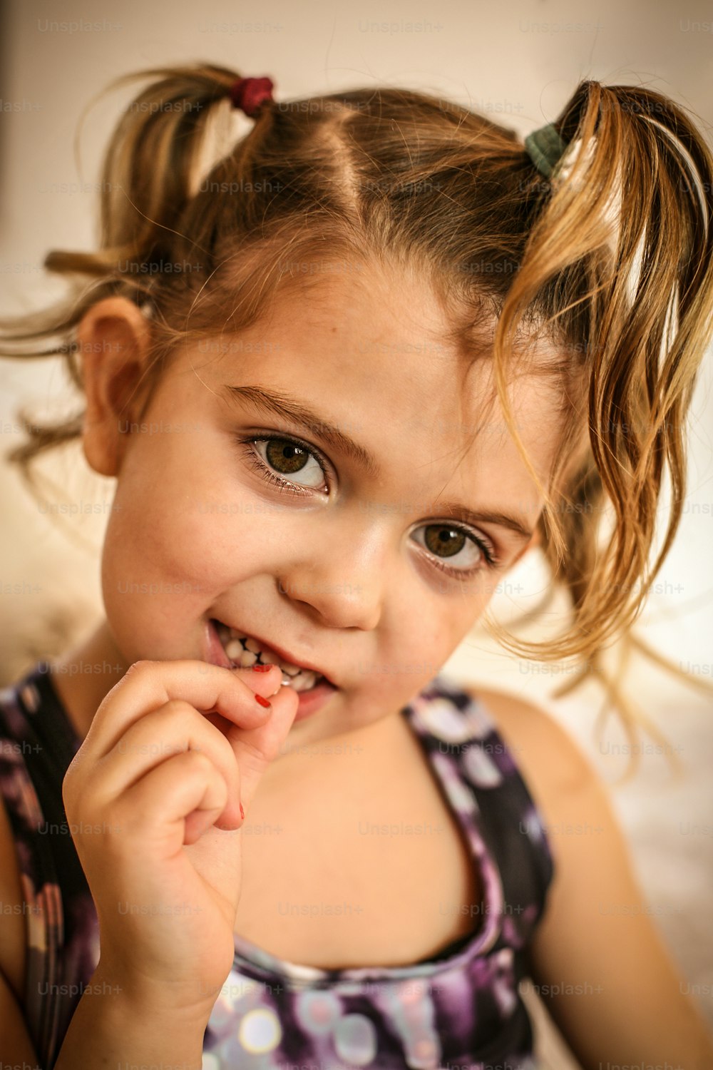Cute little girl showing missing teeth.