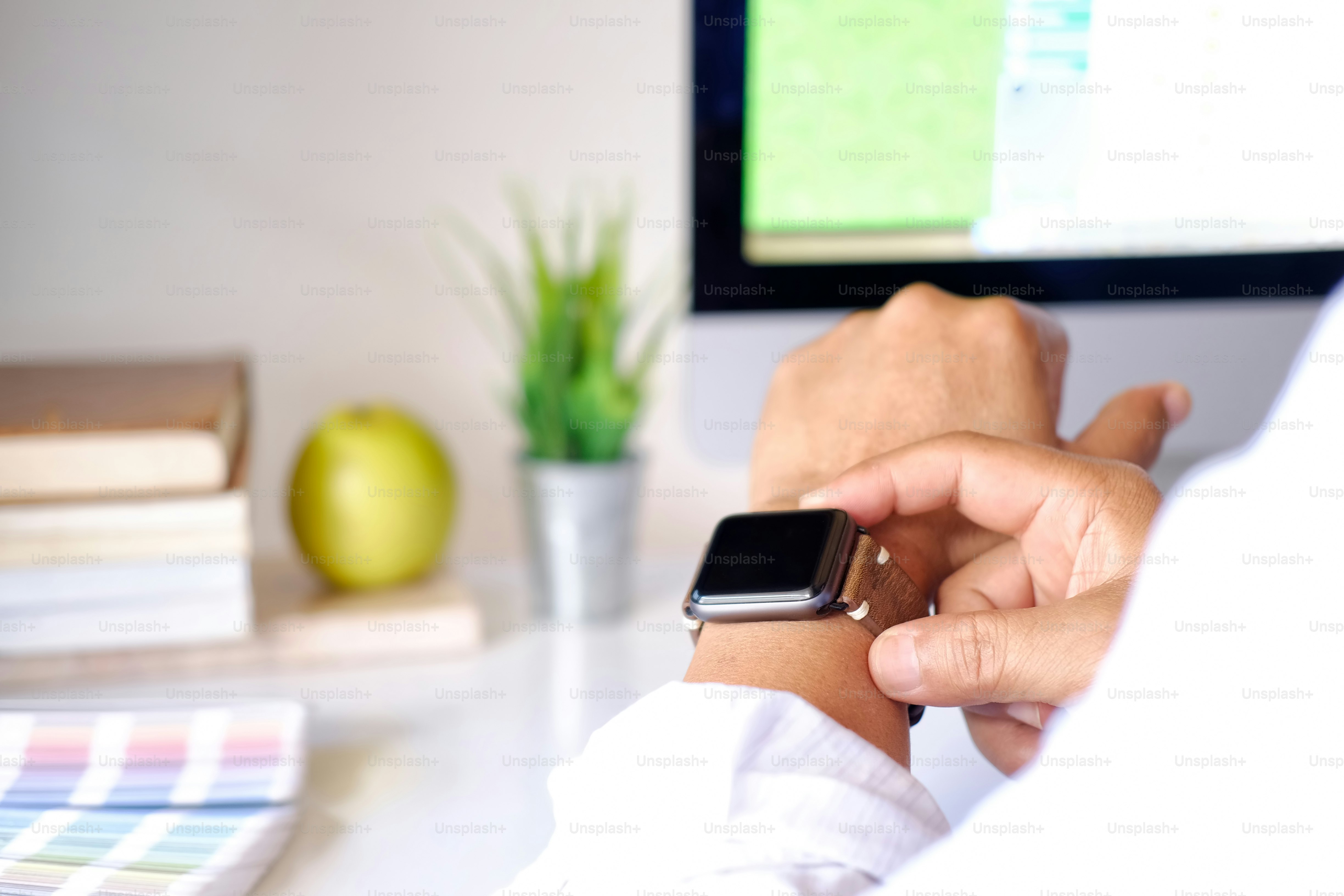 Man using smart watch on desk