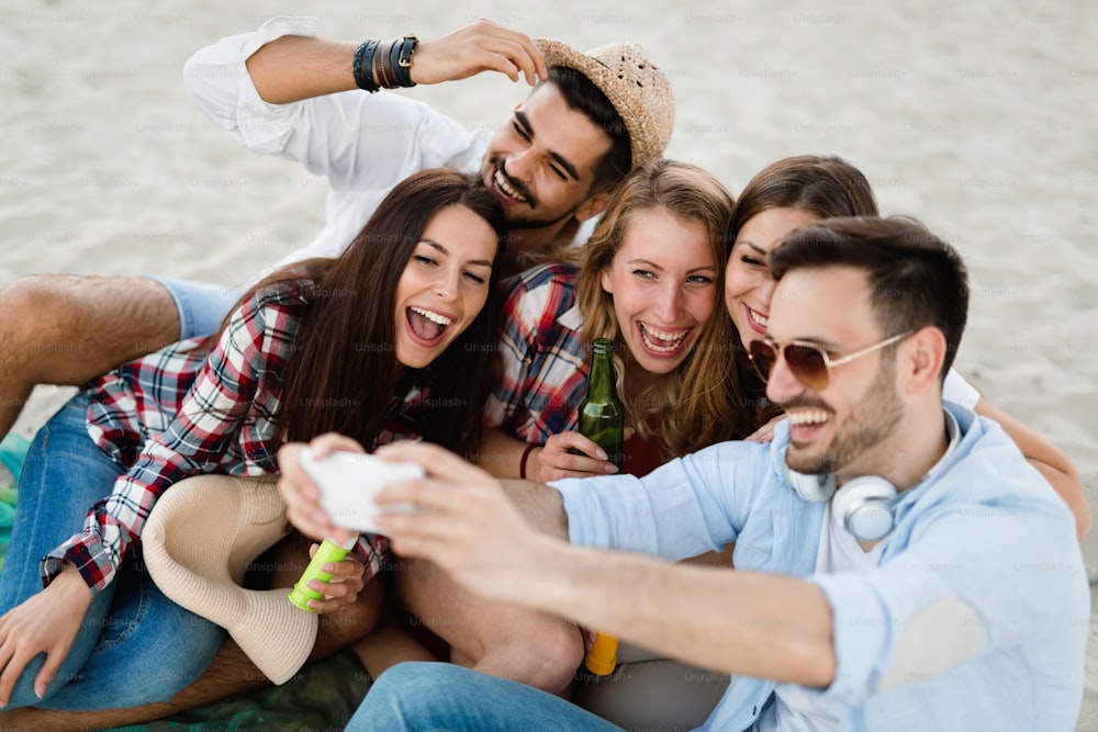 Happy young people taking selfies and having fun