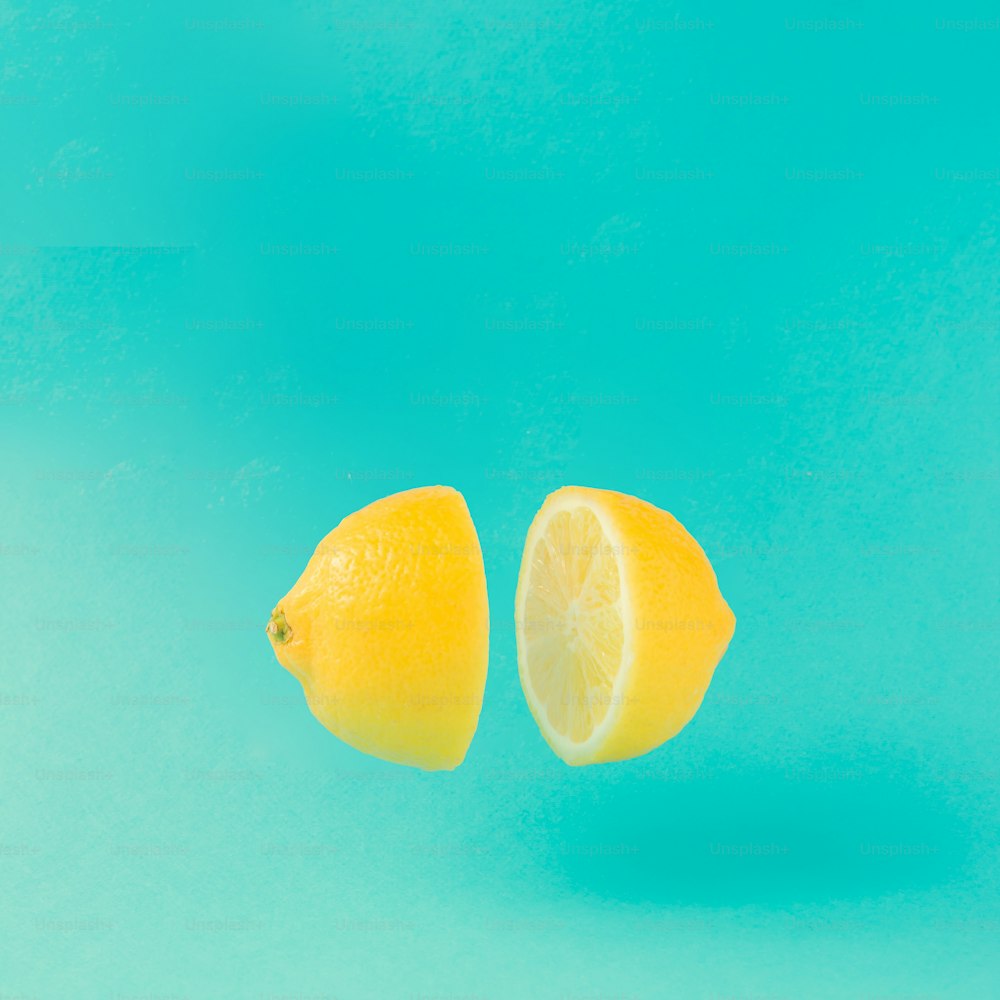 Lemon cut in half on pastel blue background. Minimal summer concept. Flat lay.