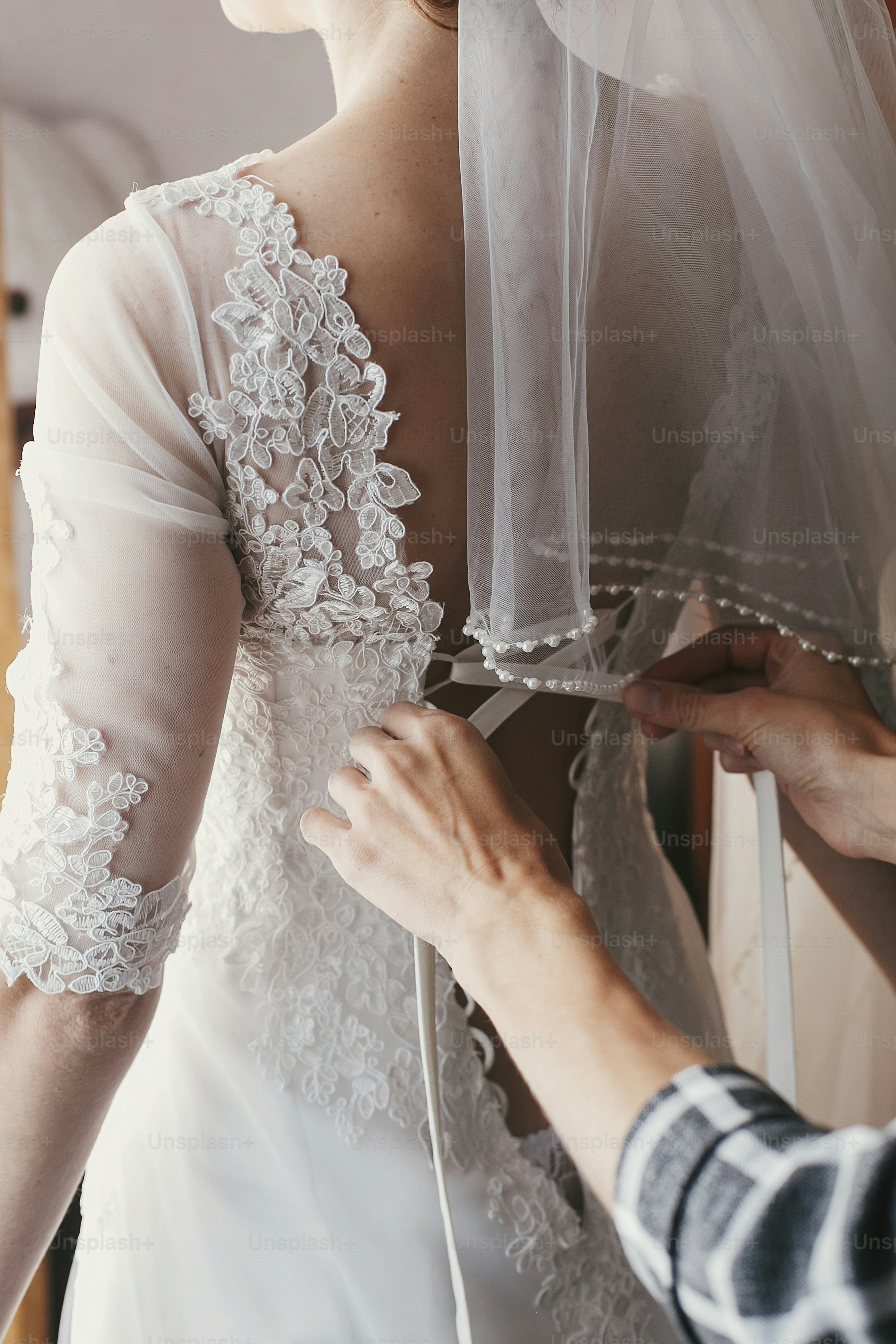 mother hands holding ribbons and helping dressing beautiful bride in morning. bridal getting ready in the morning. mom and daughter moments