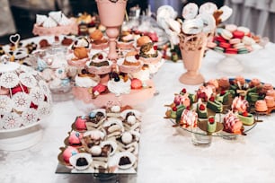 delicious cupcake. candy bar at luxury wedding reception. exclusive expensive catering. table with modern desserts, cupcakes, sweets with fruits. space for text. baby or bridal shower.