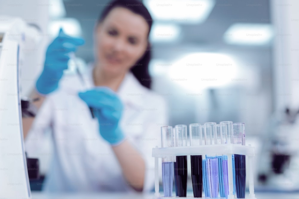 Ready for analysis. Selective focus of test tubes standing in the row on a special rack while being ready for biological analysis