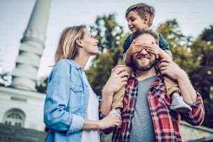 Happy family is having fun outdoors. Father, mother and son are spending time together.