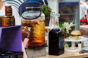 delicious lemonade in big jar and wine, serving drinks at open outdoor kitchen at market. food festival in city. tasty food-court. summer picnic