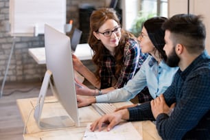 Young architects working on project in office together