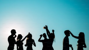 Group of people dancing at summer beach party