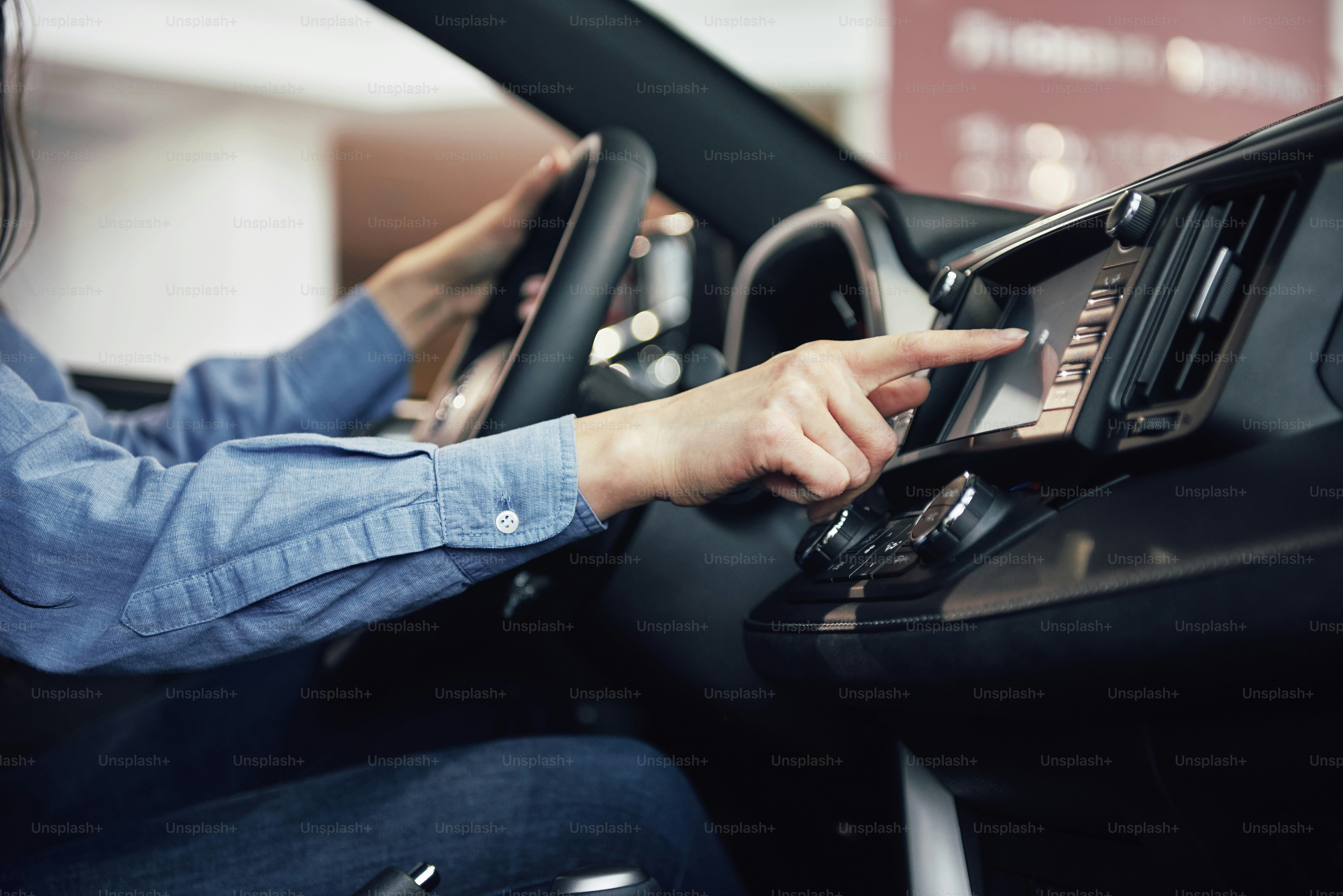 auto business, car sale, consumerism and people concept - happy woman taking car key from dealer in auto show or salon