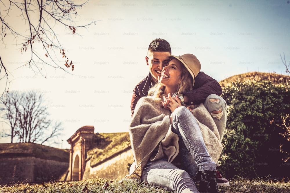 Portrait of young couple sitting in nature.
