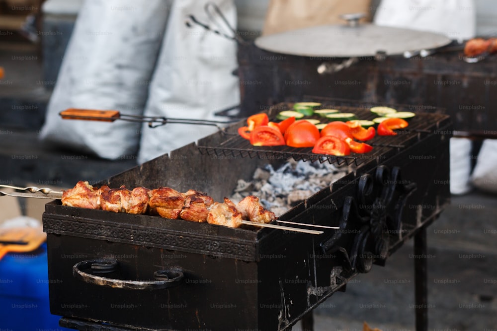Deliciosas verduras de kebab a la barbacoa a la parrilla en parrilla abierta, cocina al aire libre. Festival gastronómico en la ciudad. Sabroso asado de comidas, patio de comidas. Picnic de verano