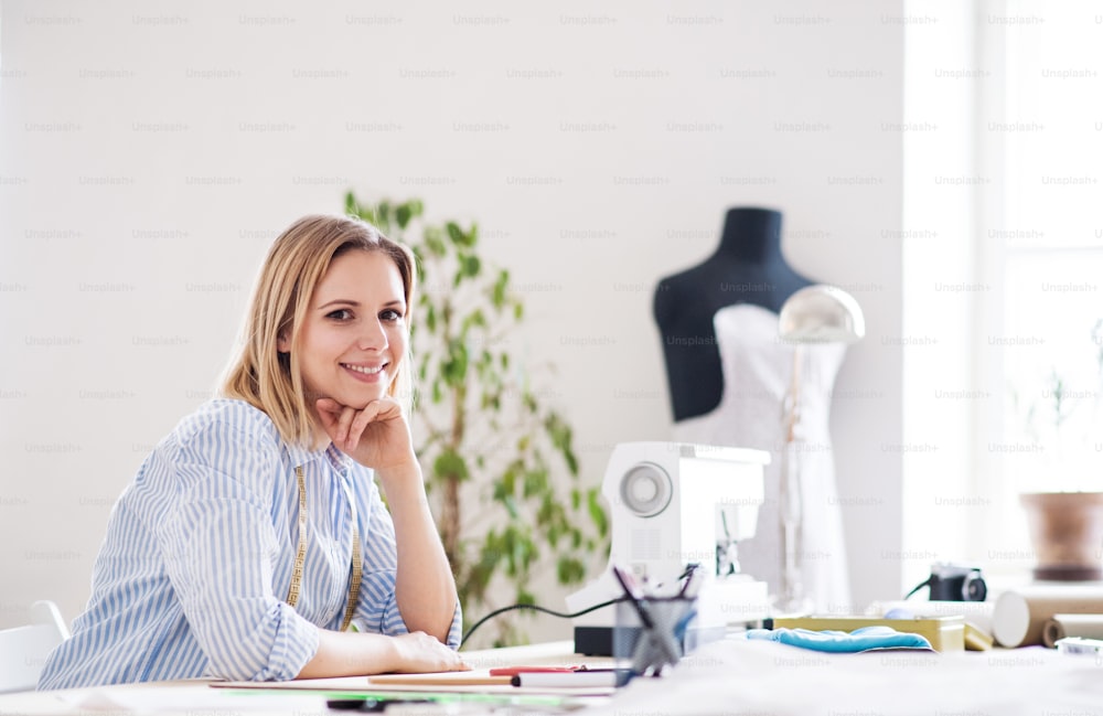 Young creative woman working in a studio, startup business.