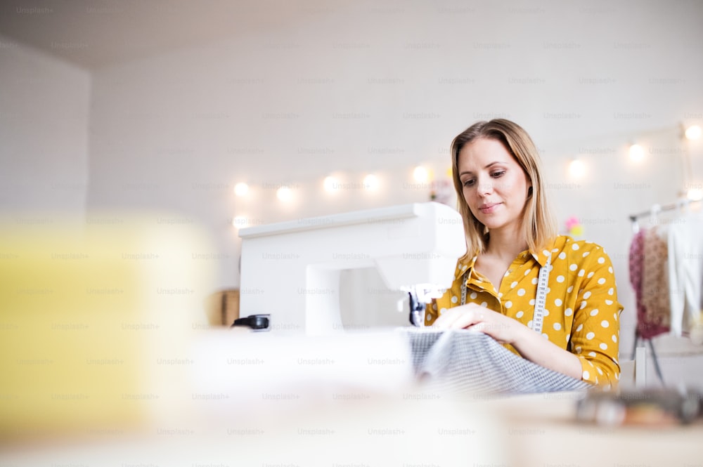 Young creative woman working in a studio, startup business.