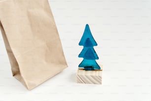 christmas tree toy with craft eco package on white background. space for text. unusual creative gift toys. seasonal holidays concept