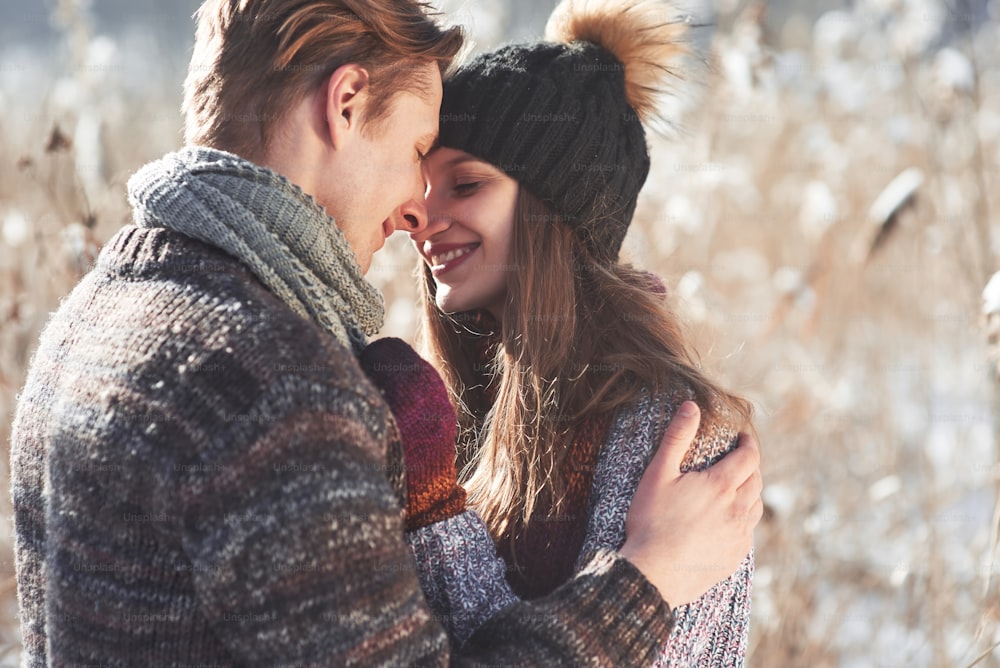 Happy Young Couple in Winter Park having fun.Family Outdoors. love