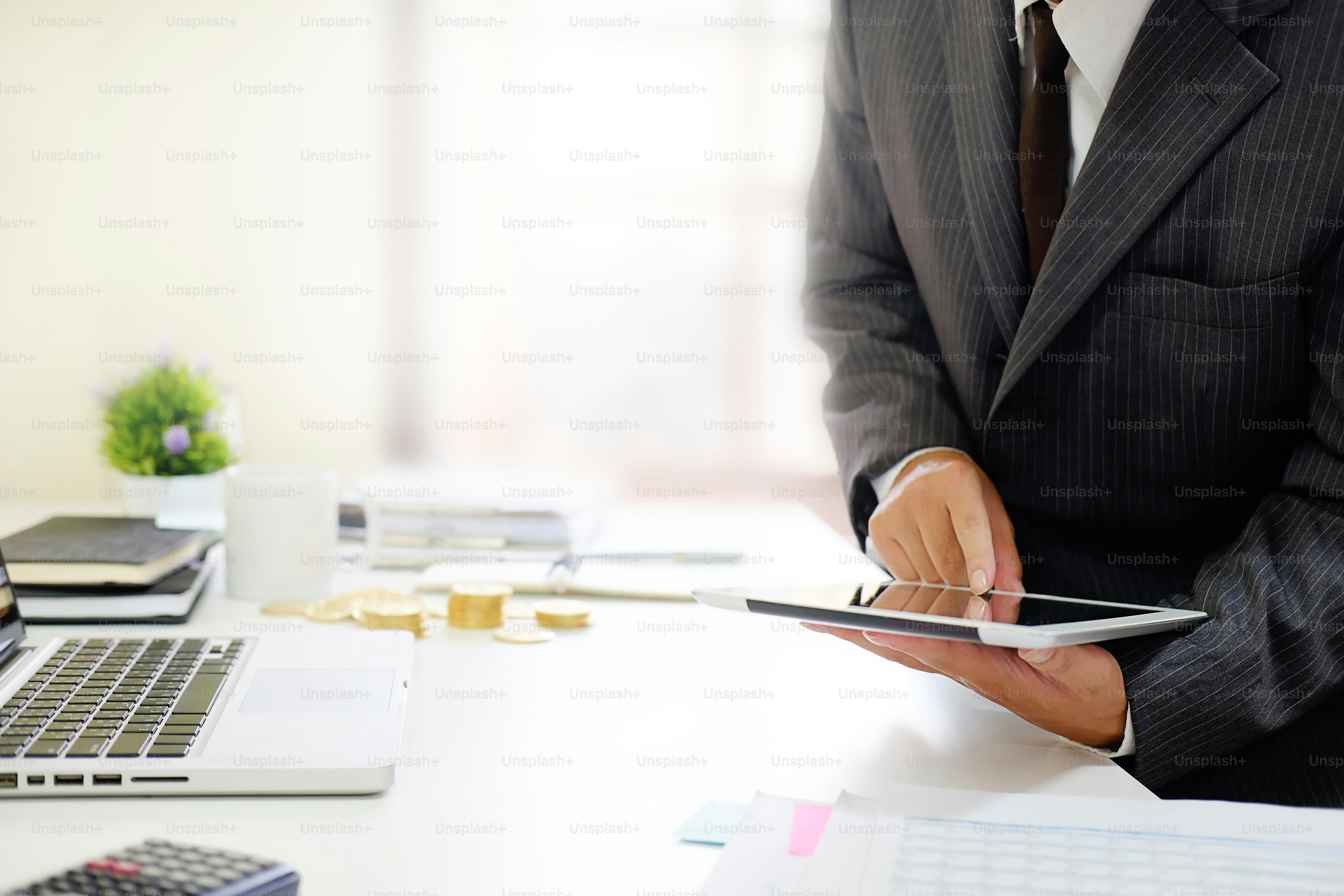 Certified public accountant, Man working on smartphone tablet computer and spreadsheet document financial data.