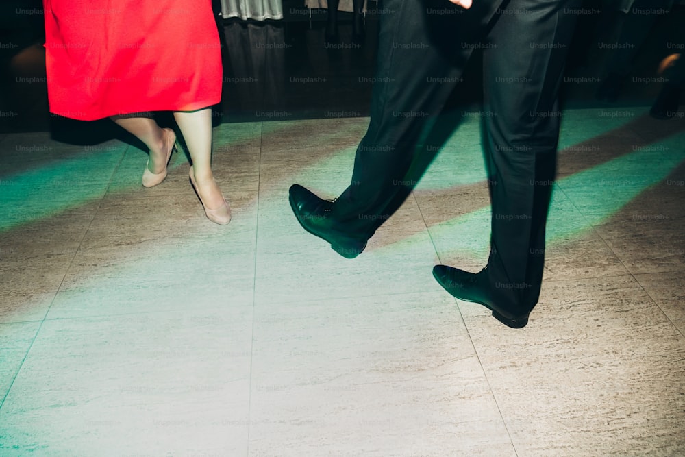 Happy, stylish couple dancing at business dinner nightclub dance party, disco lights party in restaurant, celebration concept