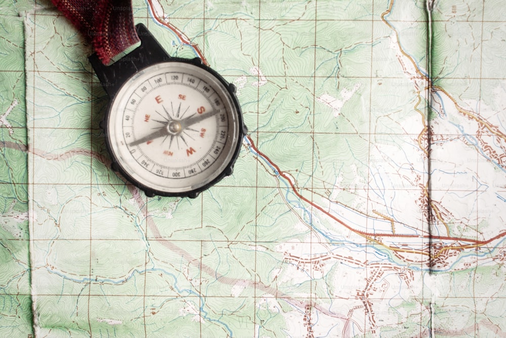 wanderlust and explore concept, old compass lying on map, top view, space for text, vintage toned image