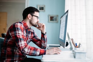 Young attractive designer working on project at home