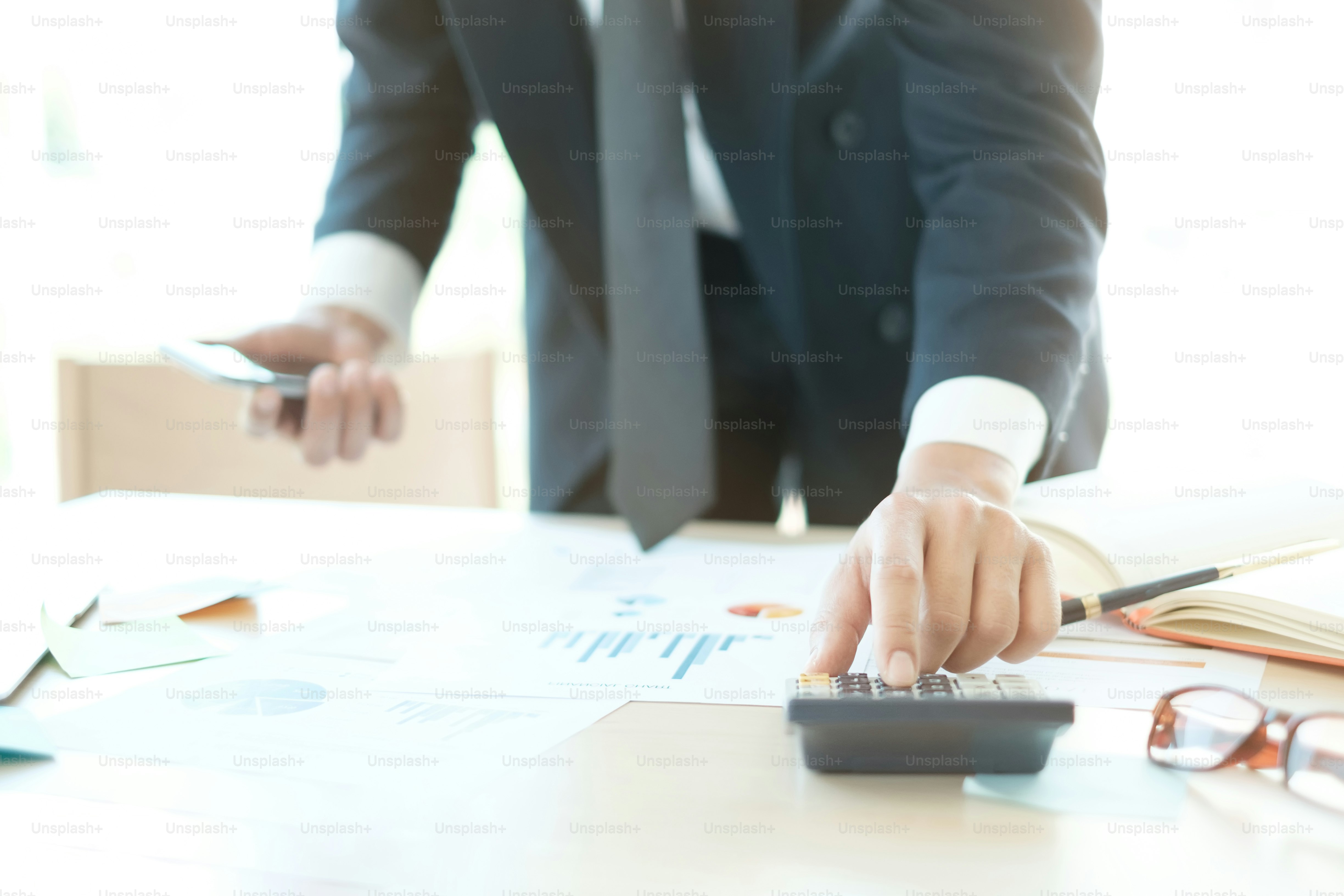 calculate of finance with business man using calculator to analysis data of financial.