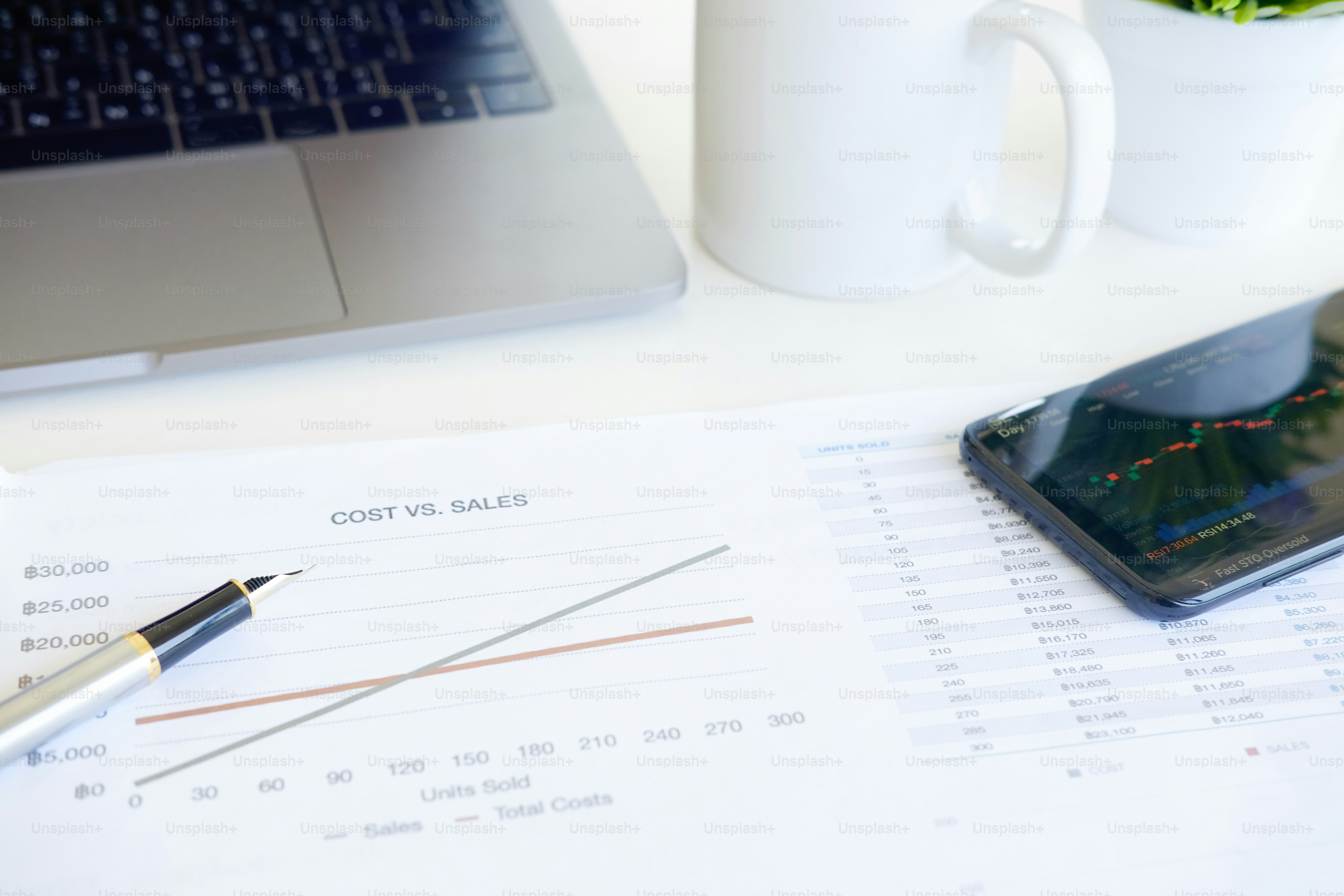 Cost financial concept, business equipment paper chart, pen with laptop ...