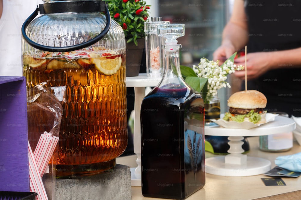 delicious lemonade in big jar and wine, serving drinks at open outdoor kitchen at market. food festival in city. tasty food-court. summer picnic