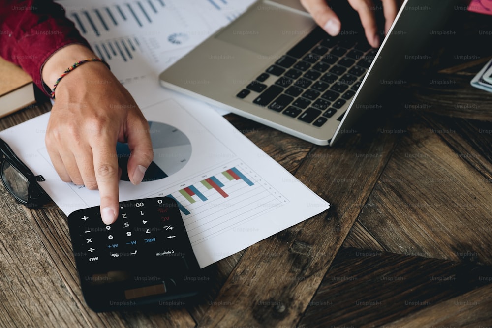 Close up view of bookkeeper or financial inspector hands making report, calculating or checking balance. Home finances, investment, economy, saving money or insurance concept