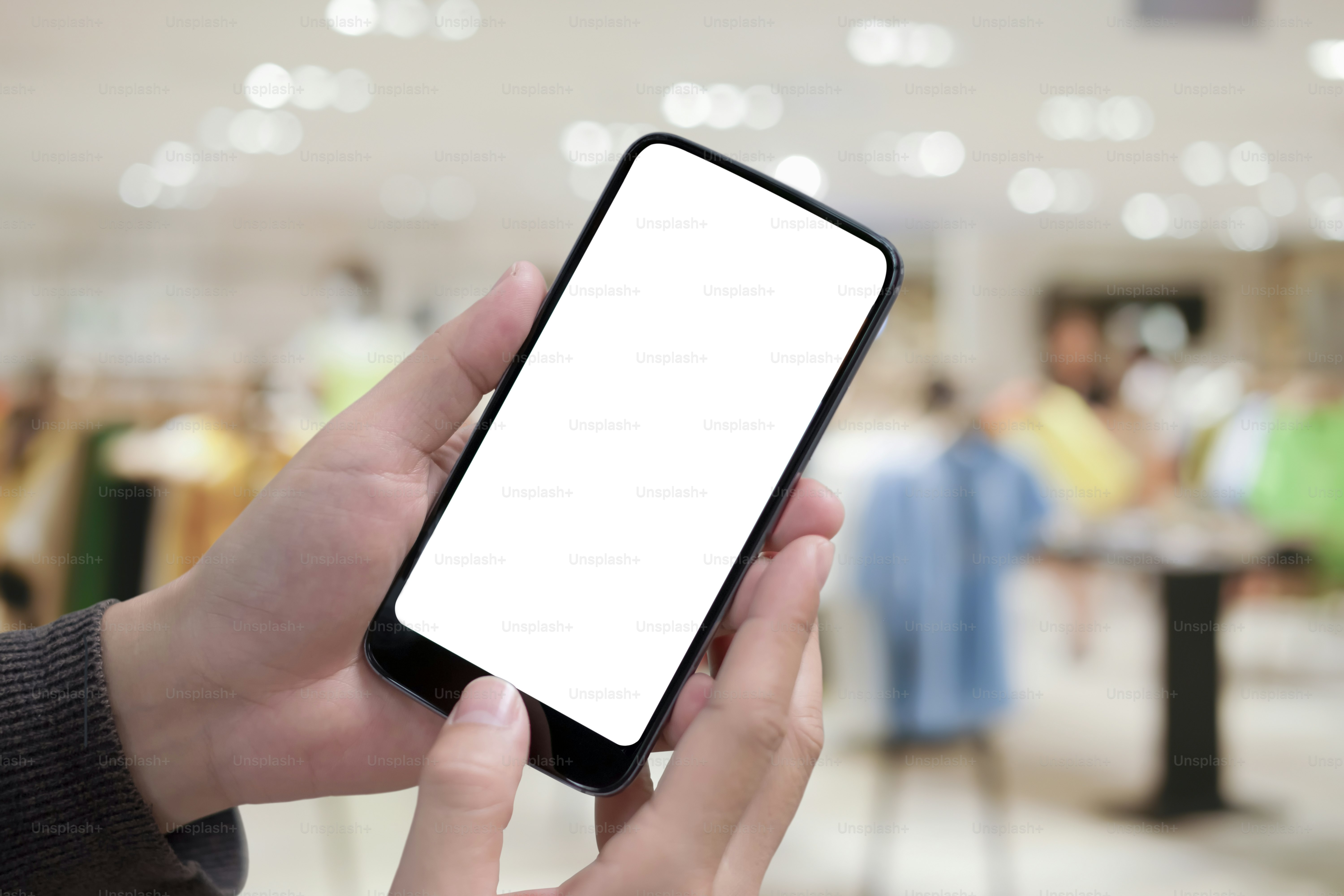 Man holding smart phone with blurred background. For Graphic display montage.