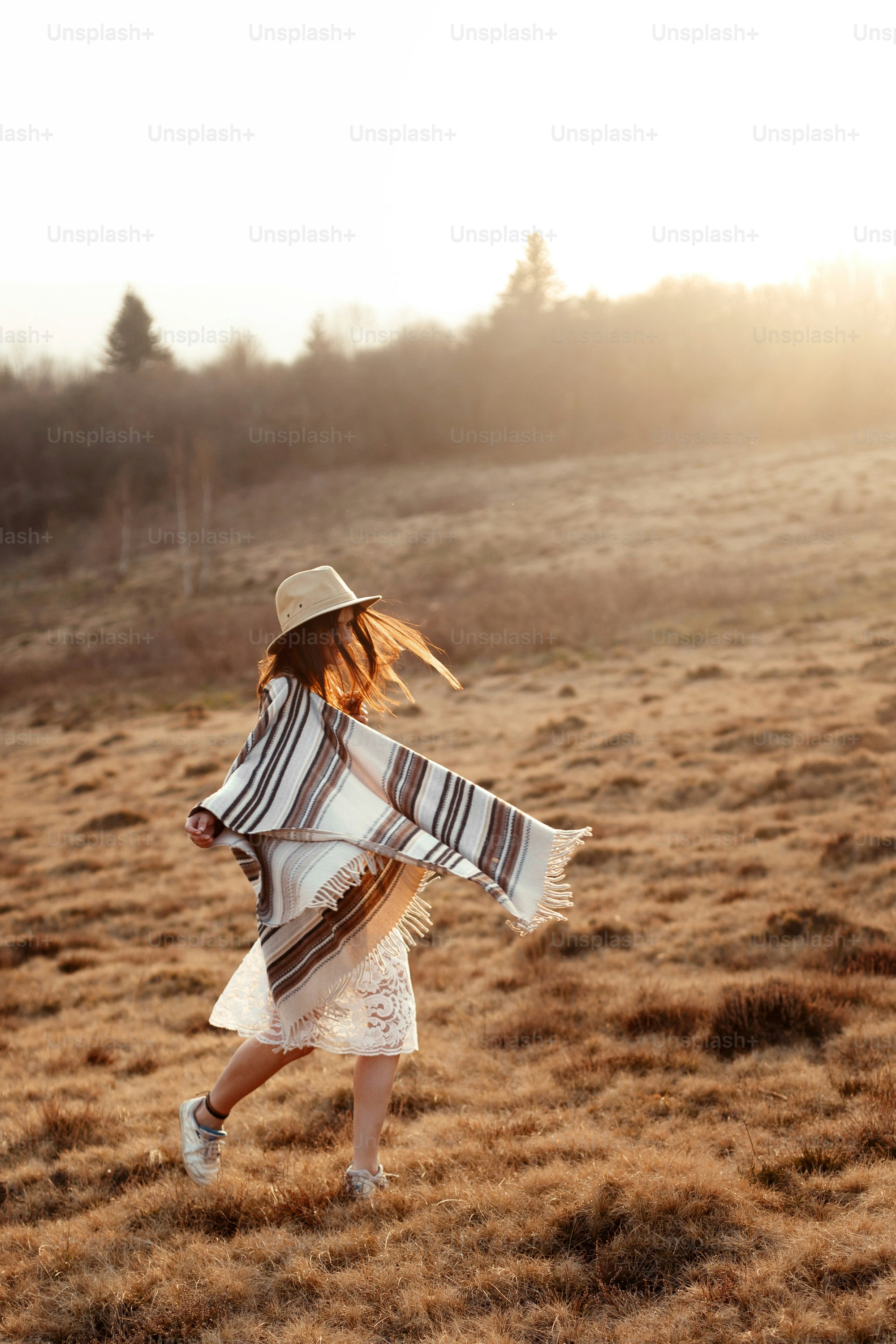 beautiful boho woman hipster enjoying sunset and having fun in mountains, true emotions