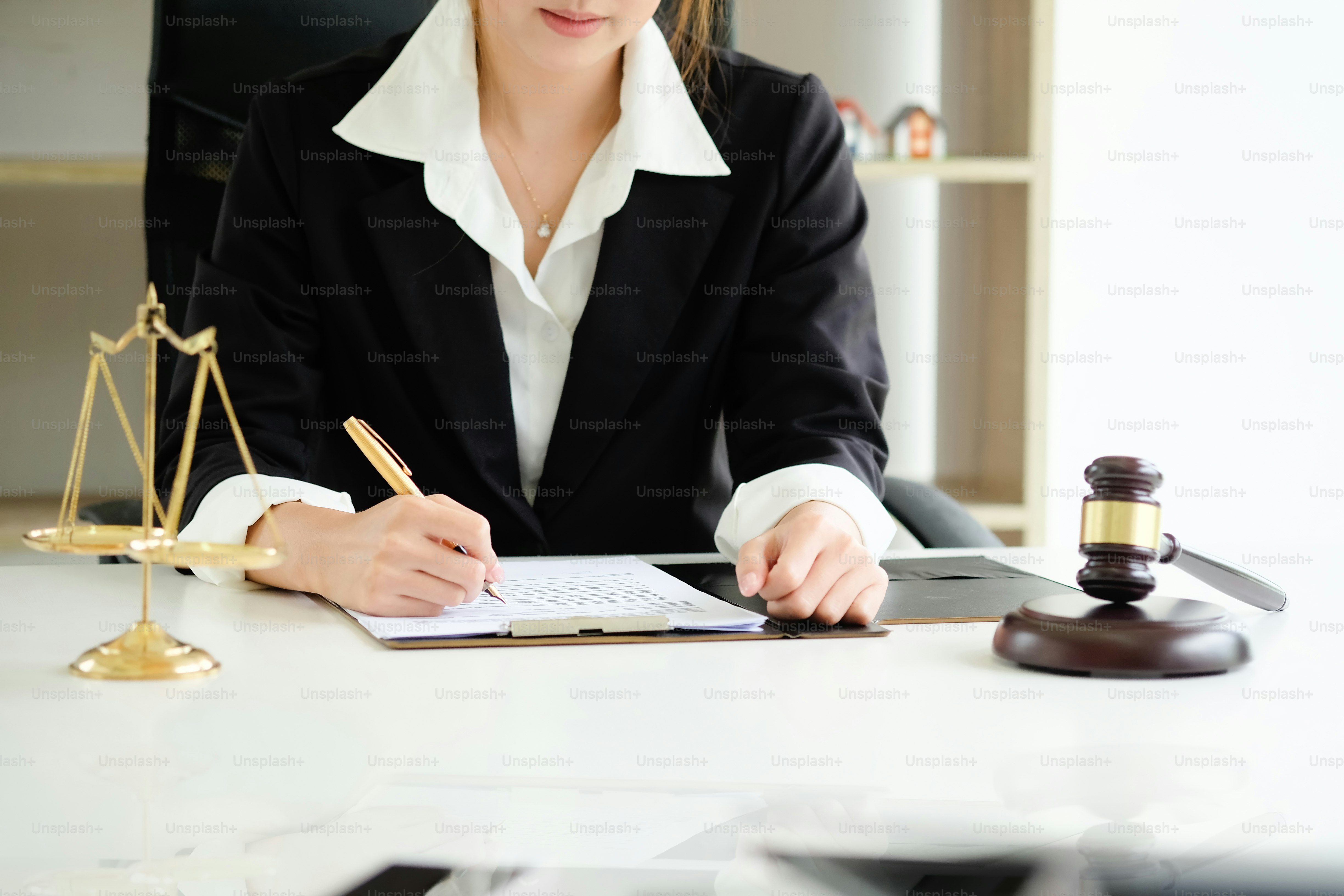 Close up Judge gavel Justice lawyers, Business woman in suit or lawyer working on a documents. Legal law, advice and justice concept