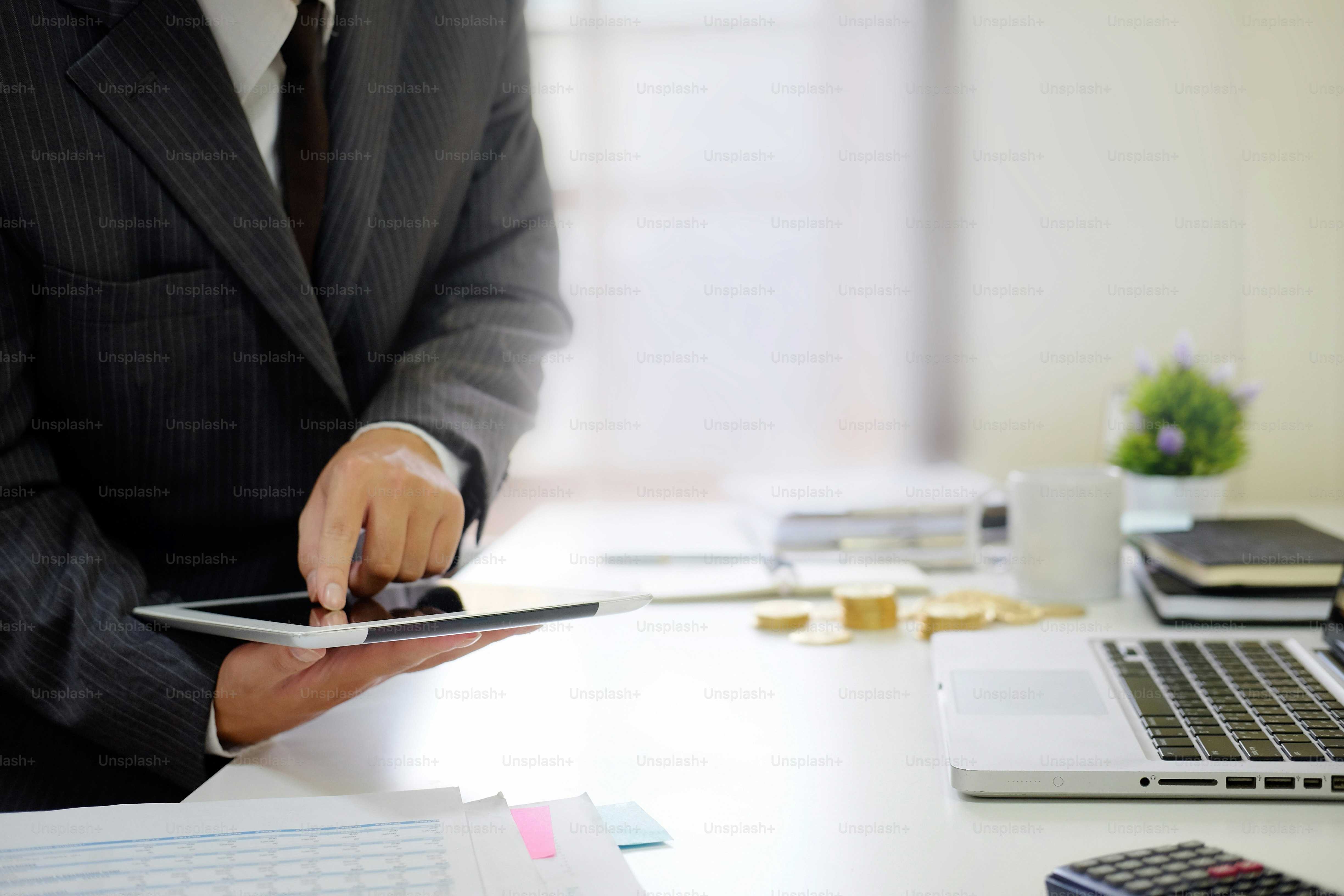 Certified public accountant, Man working on smartphone tablet computer ...
