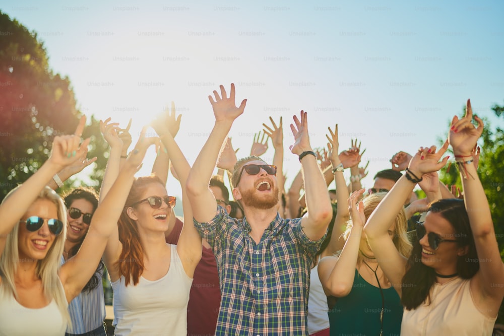 Group of people dancing and having a good time at the outdoor party/music festival