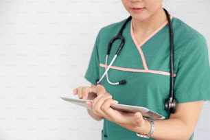 Female doctor using tablet over white background