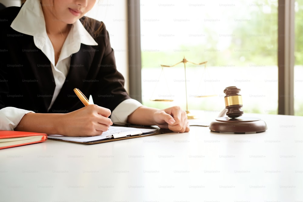 Lawyer woman working on workplace with window light at morning time.