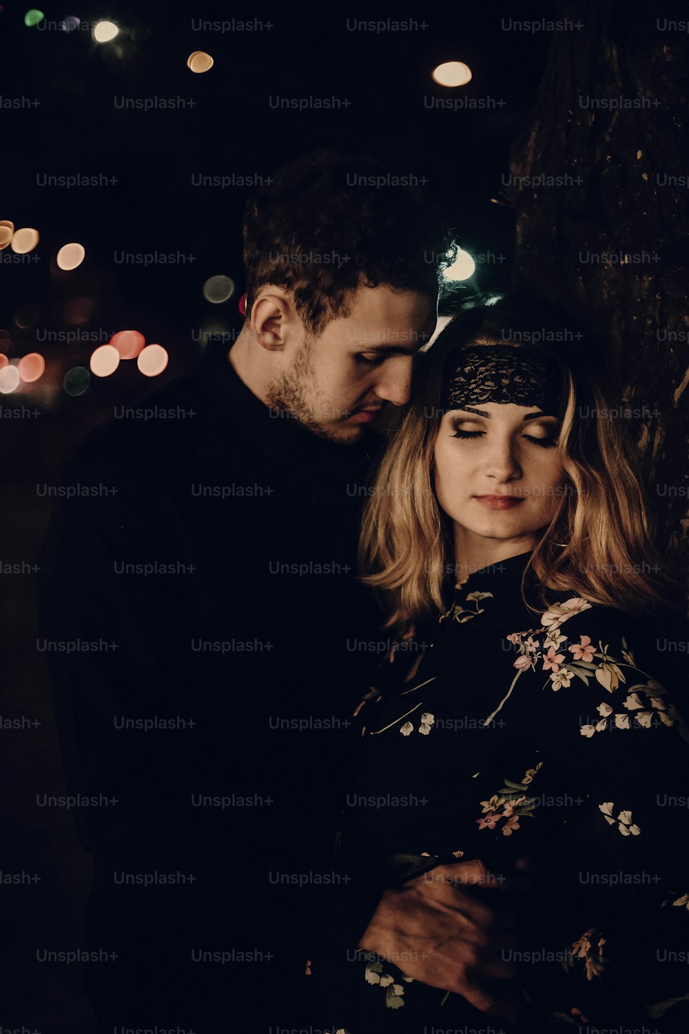 passionate lovers embracing in evening city street. stylish couple in love gently hugging in city lights. modern woman and man romantic french atmospheric moment.