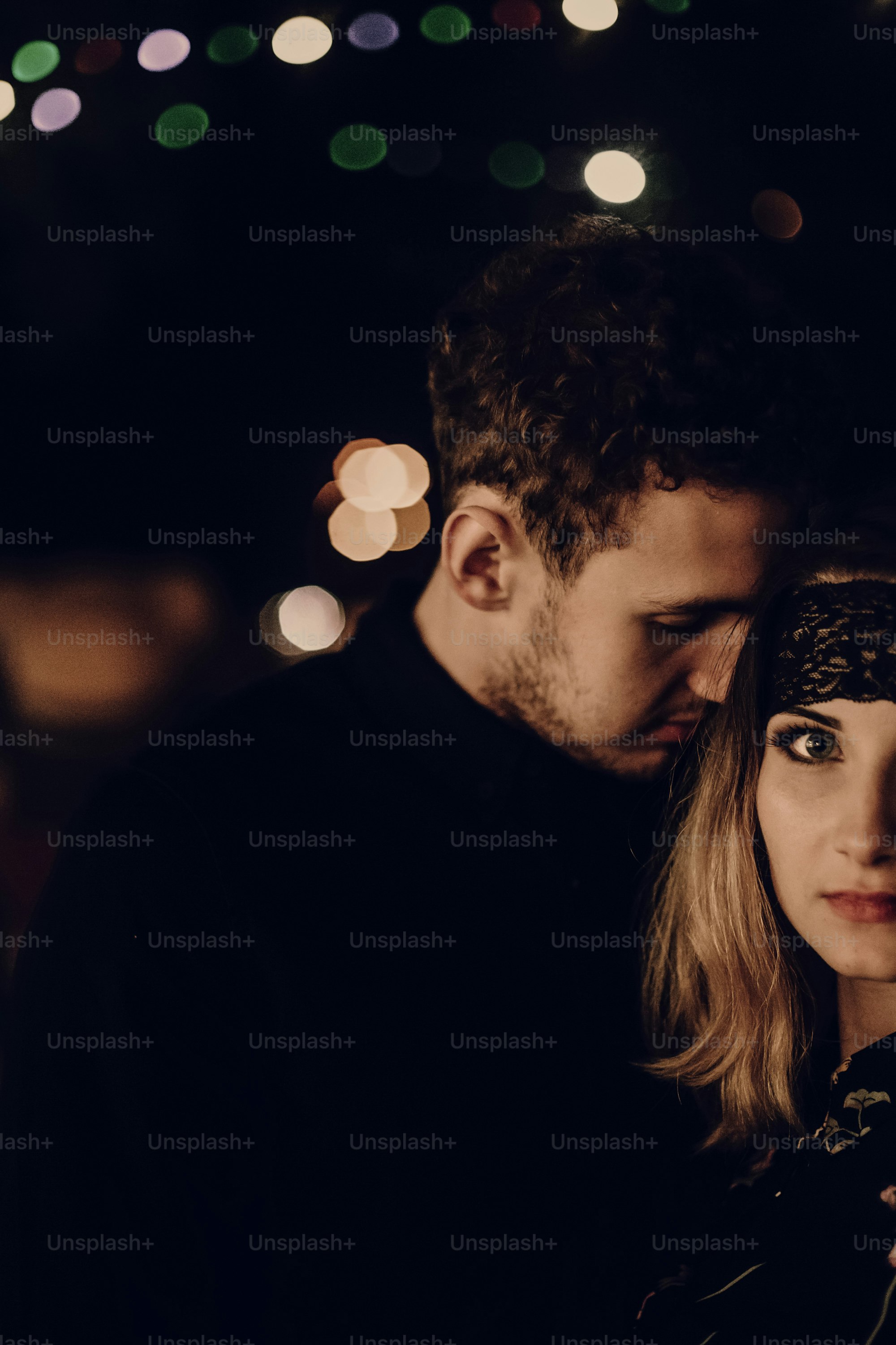 passionate gypsy bride and groom lovers embracing in evening city street. stylish couple in love gently hugging in city lights. modern woman and man romantic french atmospheric moment