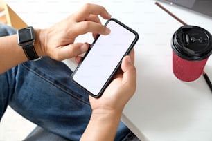 Cropped shot of man using mobile phone  on desk.