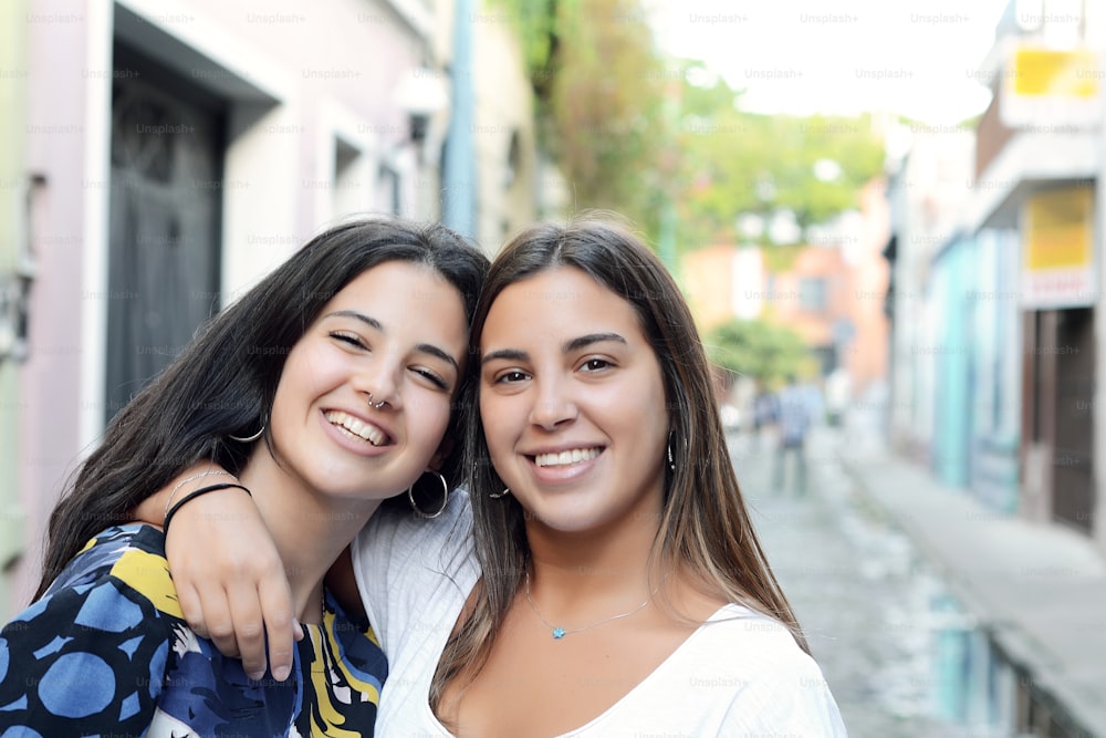 Portrait of two best friends, smiling and having fun together. Outdoor lifestyle portrait.