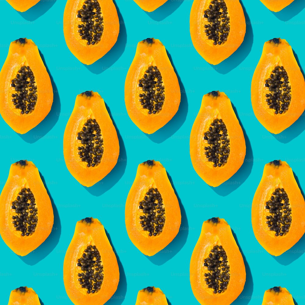 Papaya creative tropical pattern vivid blue background. Abstract summer art background. Minimal print concept. Flat lay food.