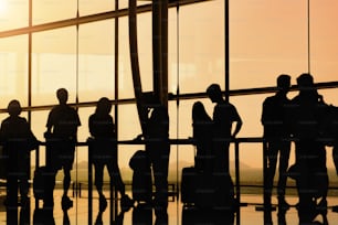 silhouette of people in queue waiting for check in at airport