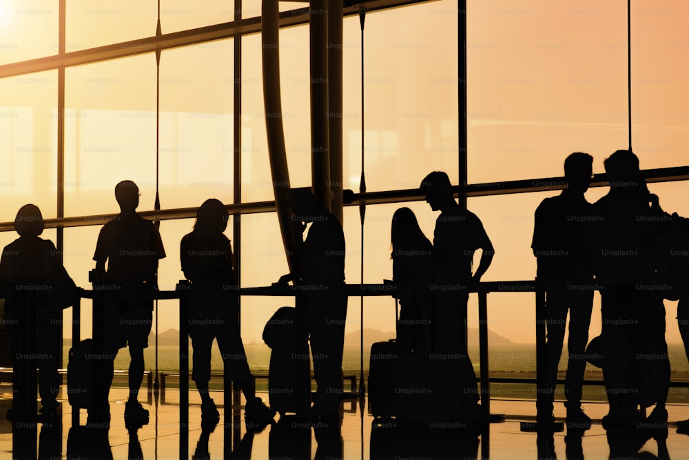 silhouette de personnes dans la file d’attente pour l’enregistrement à l’aéroport