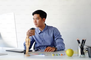 Graphic designer working with computer on table.