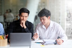 Young businessman meeting and brainstorming with laptop computer on office workplace.