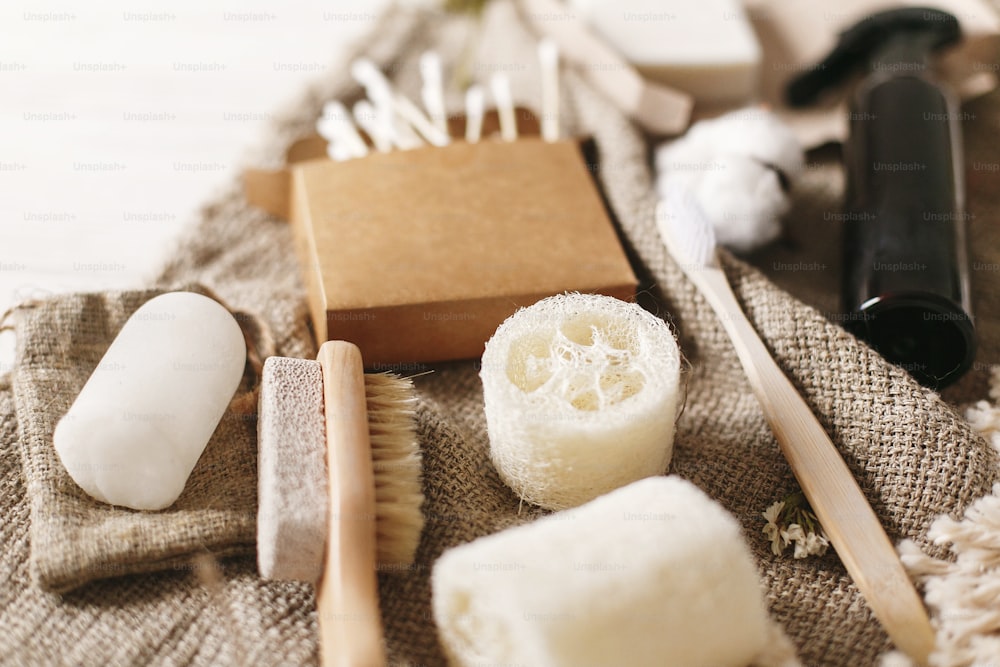 zero waste concept, sustainable lifestyle. plastic free natural eco bamboo toothbrush, coconut soap, handmade shampoo, crystal deodorant, luffa, bamboo ear sticks, brush