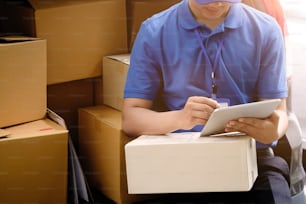 Delivery man working with box on tail truck car.