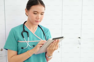 Close up asian nurse using tablet technology health care medical.